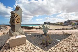a stone monument on a beach with a beach at Casa Rosi 1 in Puerto del Rosario