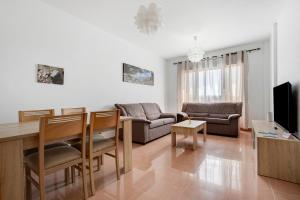 a living room with a couch and a table at Casa Rosi 1 in Puerto del Rosario