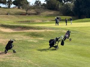 a group of golf carts on a golf course at Bacom Apartment in Caldes de Malavella