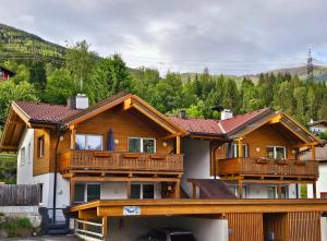 a large house with wooden balconies on top of it at Ferienwohnung Edelstein in Neukirchen am Großvenediger