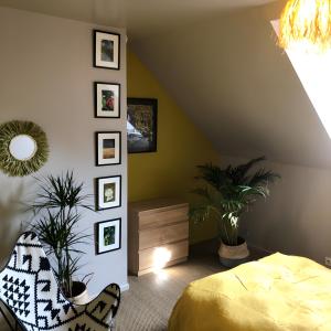 a bedroom with a bed and potted plants at Gîte Bonaty in Soulgé-sur-ouette +21 photos