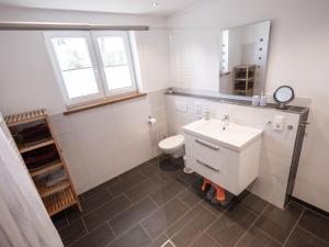 a bathroom with a white sink and a toilet at Conzen Hof am Hennesee in Erflinghausen +33 photos