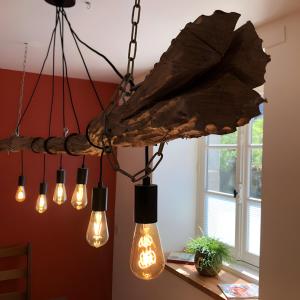 a group of lights hanging from a chandelier at Gîte Bonaty in Soulgé-sur-ouette