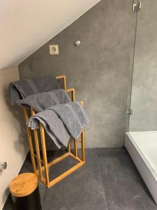 a bathroom with a pile of towels on a chair at Haus Zum Haiden in Bodman-Ludwigshafen +21 photos