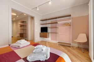 a bedroom with a bed with towels on it at Palazzo Righi in Carisolo