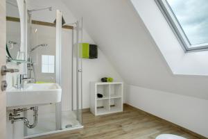 a bathroom with a sink and a shower at Biohof Stotz in Friedrichshafen +100 photos
