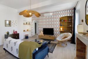 a living room with a bed and a tv at Superbe appartement centre Ajaccio in Ajaccio