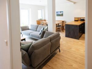 a living room with a couch and a table at Conzen Hof am Hennesee in Erflinghausen
