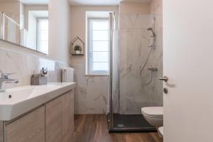 a bathroom with a shower and a sink and a toilet at Villa Vacanze Pink Lady in Tuenno +23 photos