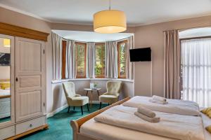 a bedroom with a bed and a table and chairs at Chalet Sonneck - Seefeld in Seefeld in Tirol
