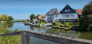 a bridge over a river with houses and boats at Ferienwohnung Albatros Steinhude in Wunstorf
