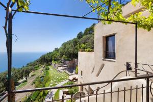 a building with a balcony overlooking the ocean at Agriturismo Bricco in Finale Ligure
