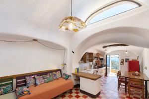 a living room with a couch and a table at Agriturismo Bricco in Finale Ligure