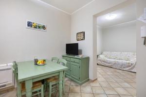 a room with a table and a television and a bedroom at Ultimo Tiro - app Secondo Tiro in Cisano sul Neva