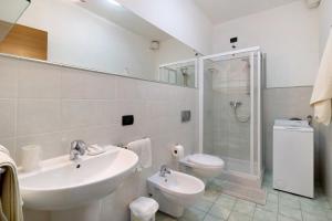 a bathroom with a sink and a toilet and a shower at Ultimo Tiro - app Secondo Tiro in Cisano sul Neva +12 photos