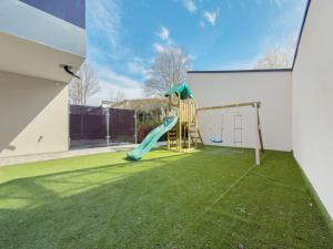 a backyard with a playground with a slide at Apartment Aura in Mengen