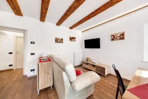 a living room with a couch and a table at Appartamento Bucaneve - Padola in Padola