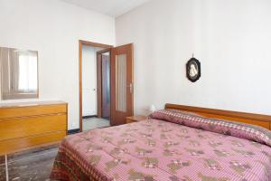 a bedroom with a bed and a clock on the wall at Casa Bruno e Iris in Levanto