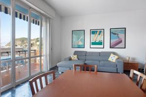 a living room with a table and a couch at Casa Bruno e Iris in Levanto