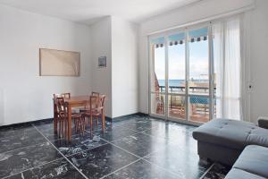 a living room with a table and chairs and a couch at Casa Bruno e Iris in Levanto +8 photos