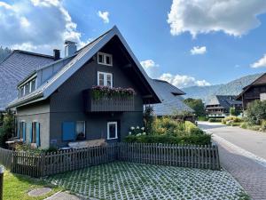 a black house with a fence in front of it at Backhüsli am Bauerngarten in St. Blasien