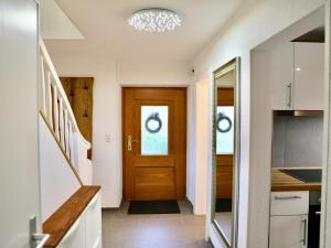 a hallway with a wooden door in a house at Backhüsli am Bauerngarten in St. Blasien