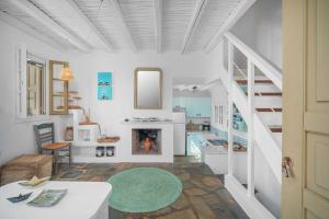 a living room with a staircase and a fireplace at Karavi in Rámos +26 photos