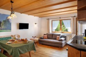 a living room with a couch and a table at Ferienwohnung Waxensteinblick in Grainau