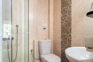 a bathroom with a shower and a toilet and a sink at Nontas Home 24 in Kalamitsi