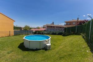 a bath tub sitting in the grass in a yard at Casa Alval in Villacastín