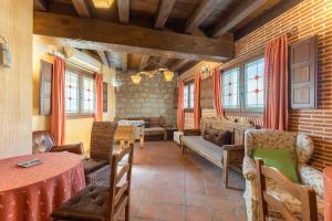 a living room with a couch and a table at Casa Alval in Villacastín