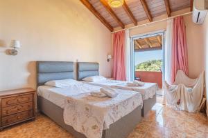 a bedroom with two beds and a large window at Arianna Grand apartment in Corfu +20 photos