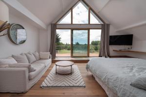 a living room with a bed and a large window at Suite Cathédrale - Ty Castel in Ploeren