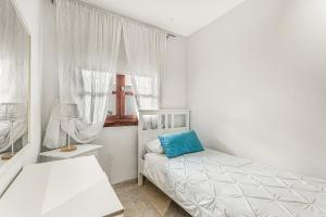 a white bedroom with a bed and a window at Villa Cassis in Adeje +22 photos