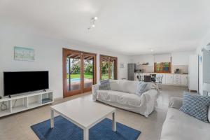 a living room with a couch and a tv at Villa Cassis in Adeje