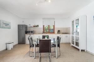 a kitchen with a glass table and chairs at Villa Cassis in Adeje