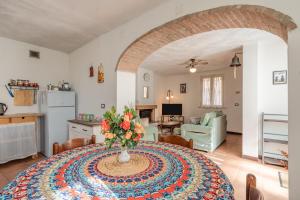 a living room with a table with a vase of flowers on it at Casa Simi - Holiday Home in Chiesina Uzzanese