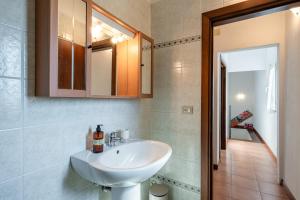 a bathroom with a sink and a mirror at Casa Simi - Holiday Home in Chiesina Uzzanese +13 photos