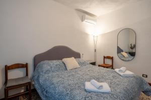 a bedroom with a bed with two towels on it at Casa Simi - Holiday Home in Chiesina Uzzanese