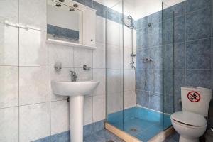 a bathroom with a toilet and a sink and a shower at Iguana studio 12 in Preveza +18 photos