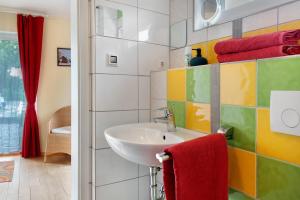 a bathroom with a sink and a red towel at Landhüsli Illmensee in Illmensee +21 photos