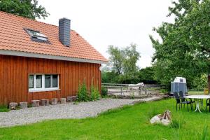 a red building with a table at Landhüsli Illmensee in Illmensee