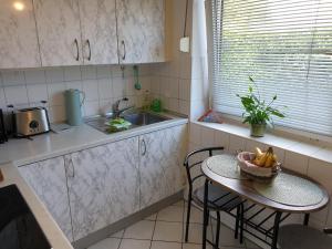 a kitchen with a table with a bowl of fruit on it at Ferienwohnung Strandperle-Schilksee in Schilksee