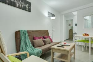 a living room with a couch and a table at 1b Srv in Vecindario