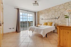 a bedroom with a bed and a large window at Villa Christisay in San Bartolomé +36 photos
