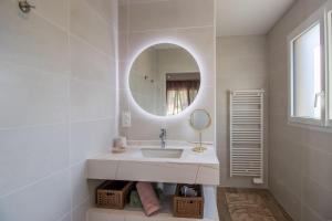 a white bathroom with a sink and a mirror at Gite le Pic Epeiche in Sarlat-la-Canéda +15 photos