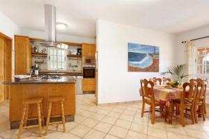 a kitchen with a table and chairs and a dining room at Villa Christisay in San Bartolomé