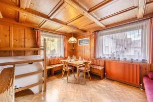 a dining room with a table and a window at Ferienwohnung Ainhauser in Campolasta +17 photos