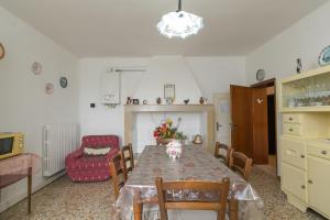 a dining room with a table and a chair at Appartamento Stella in Chianni +18 photos