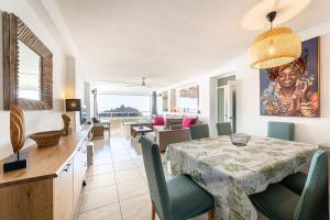 a dining room and living room with a table and chairs at Espejo del Mar in Almería